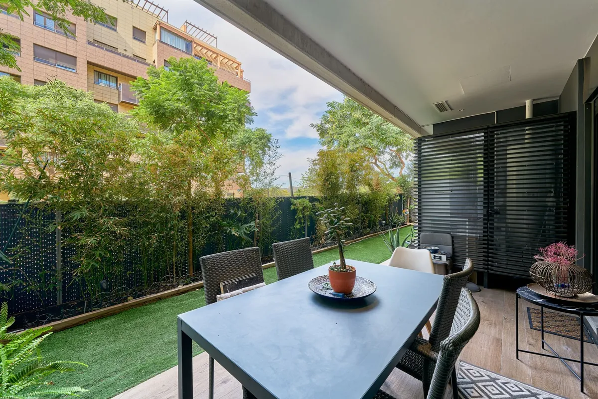 Private outdoor dining space beside the apartment’s landscaped terrace