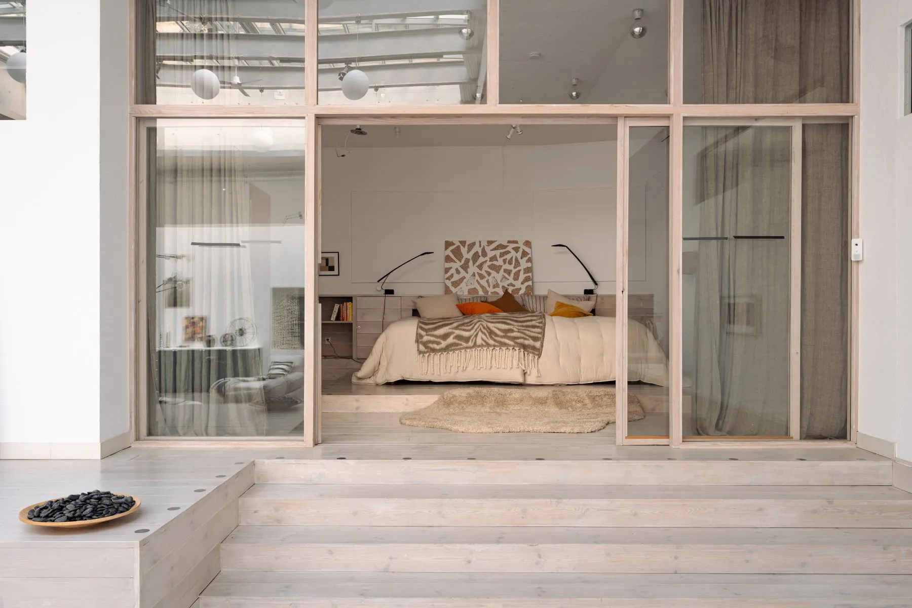 Glazed bedroom suite overlooking the architectural living space