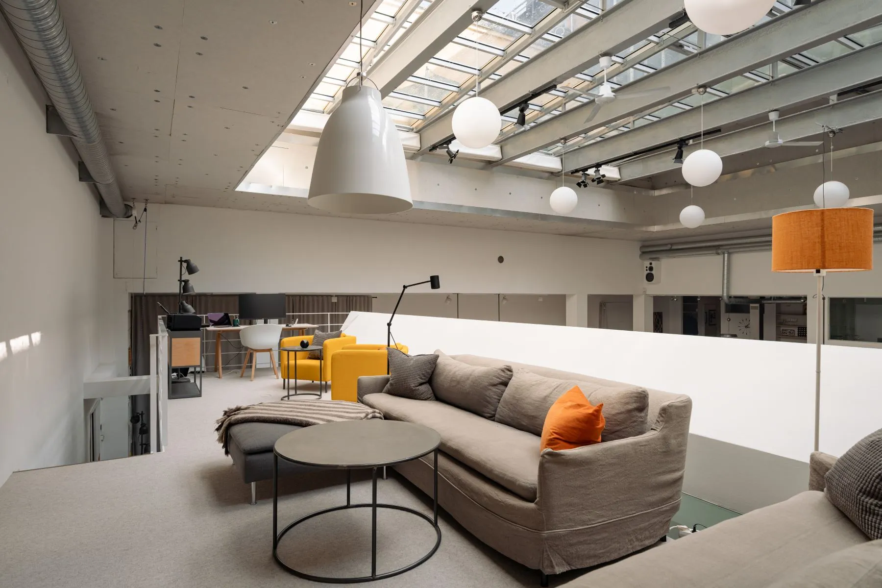 Private mezzanine lounge overlooking the skylit main reception space