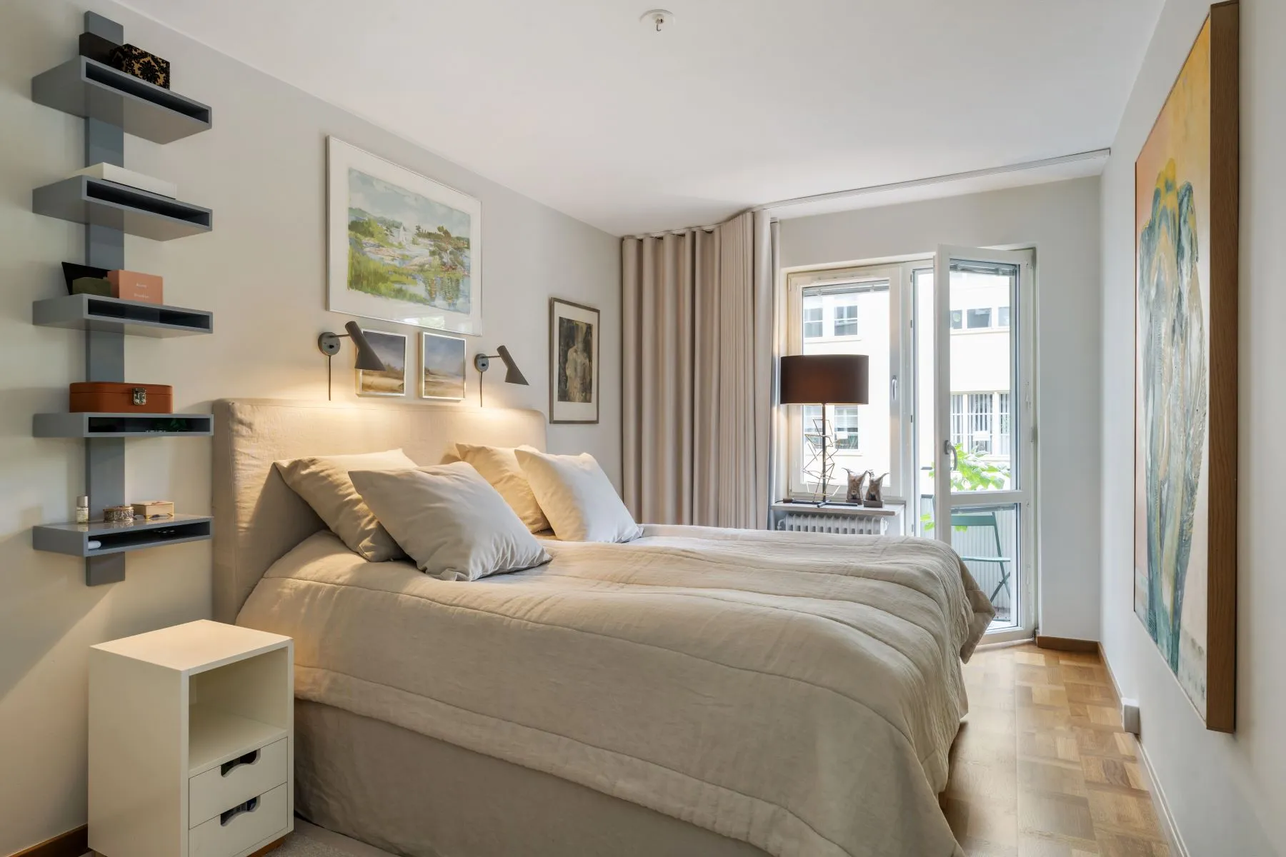 Courtyard-facing principal bedroom with balcony doors and fitted wardrobes
