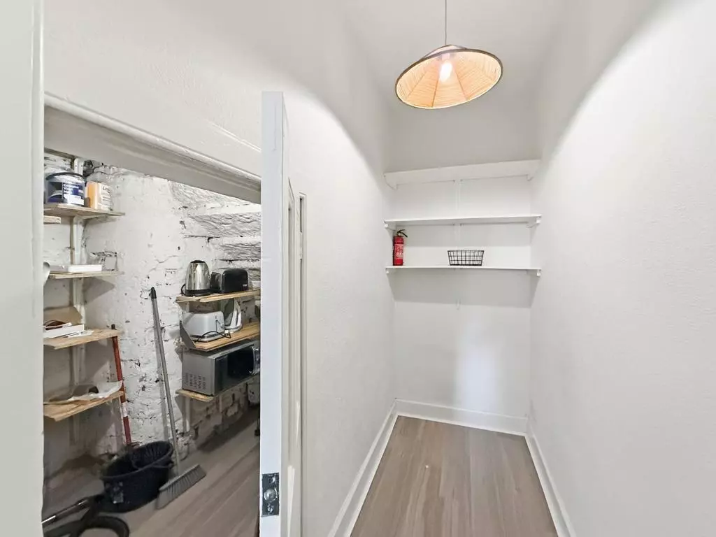 Convenient walk-in storage area with shelving