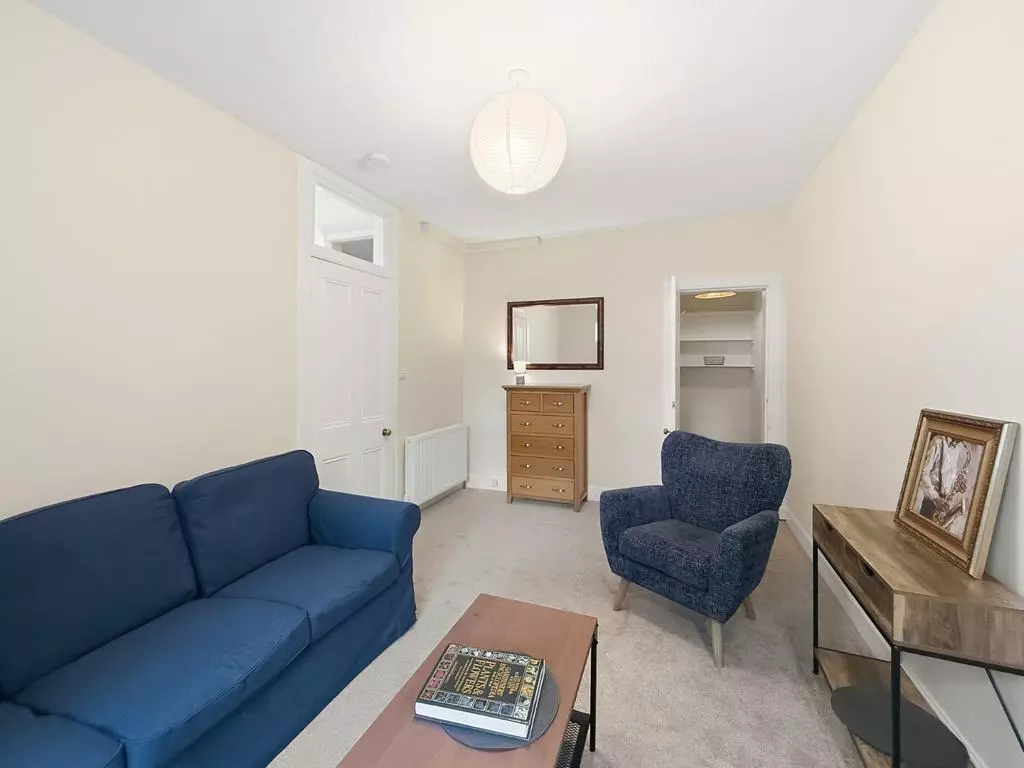 Spacious sitting room viewed toward the apartment hallway