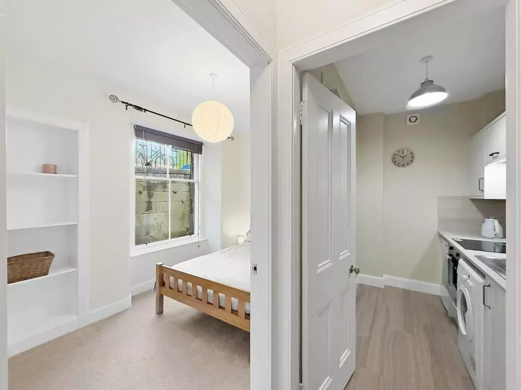 Bedroom entrance beside the separate fitted kitchen