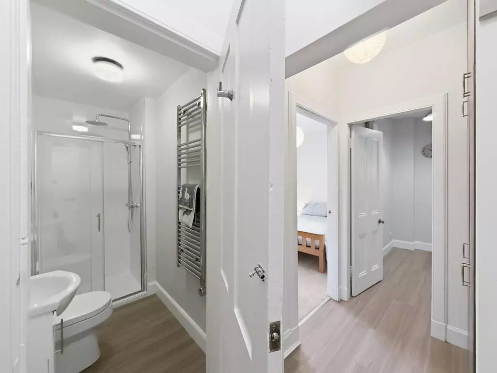 Hallway leading between the bedroom and modern shower room