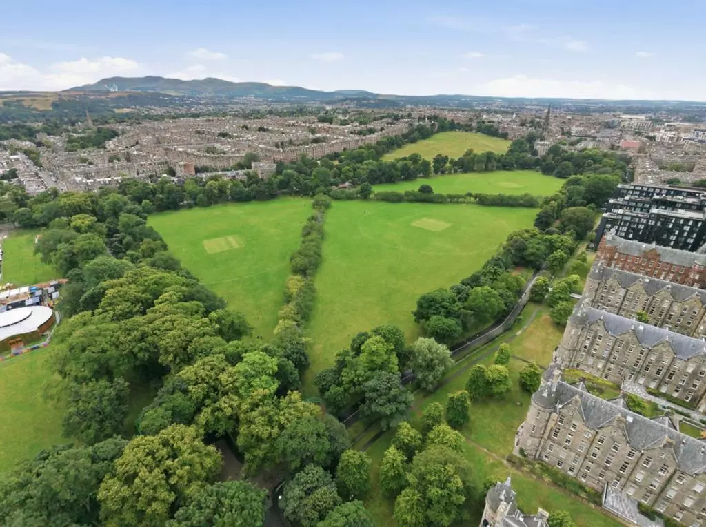 Elevated view across The Meadows and the Edinburgh skyline