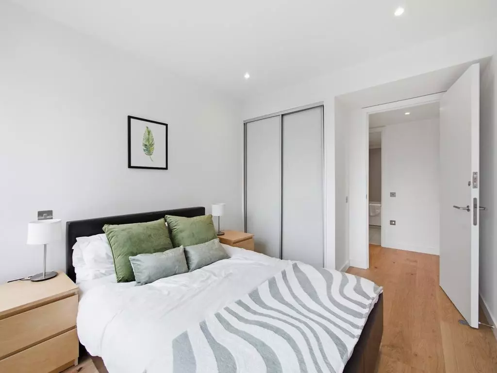 Second bedroom with built-in wardrobe and wooden floor