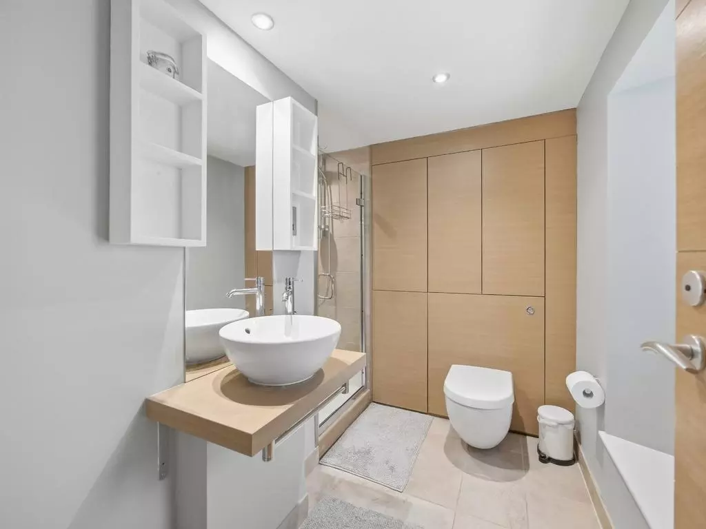 Modern bathroom with vanity basin and fitted storage