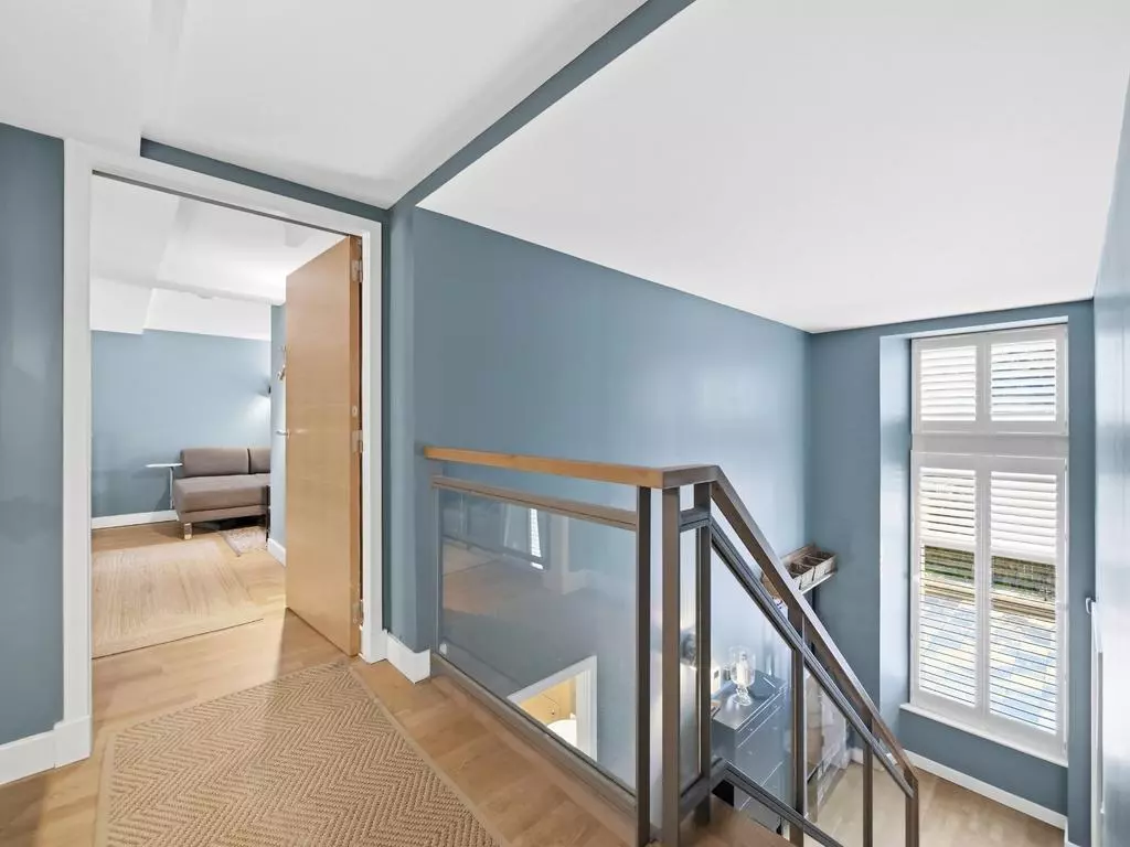 Upper landing overlooking the double-height living space