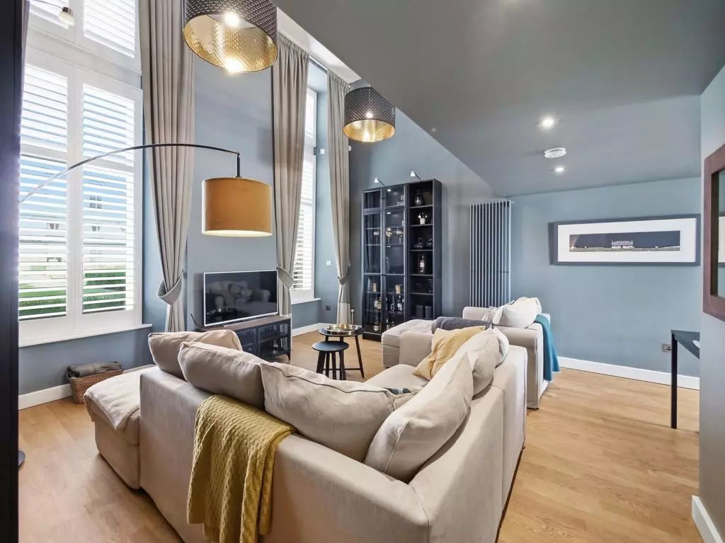 Bright contemporary sitting area with high windows