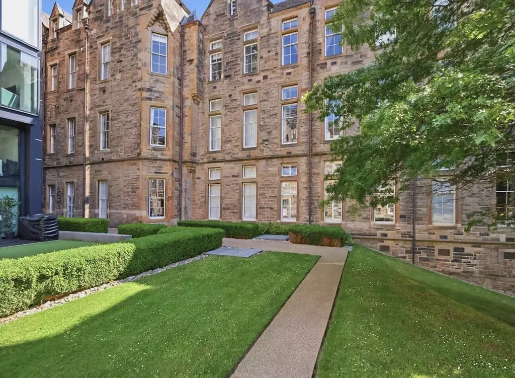 Landscaped communal garden surrounded by historic buildings