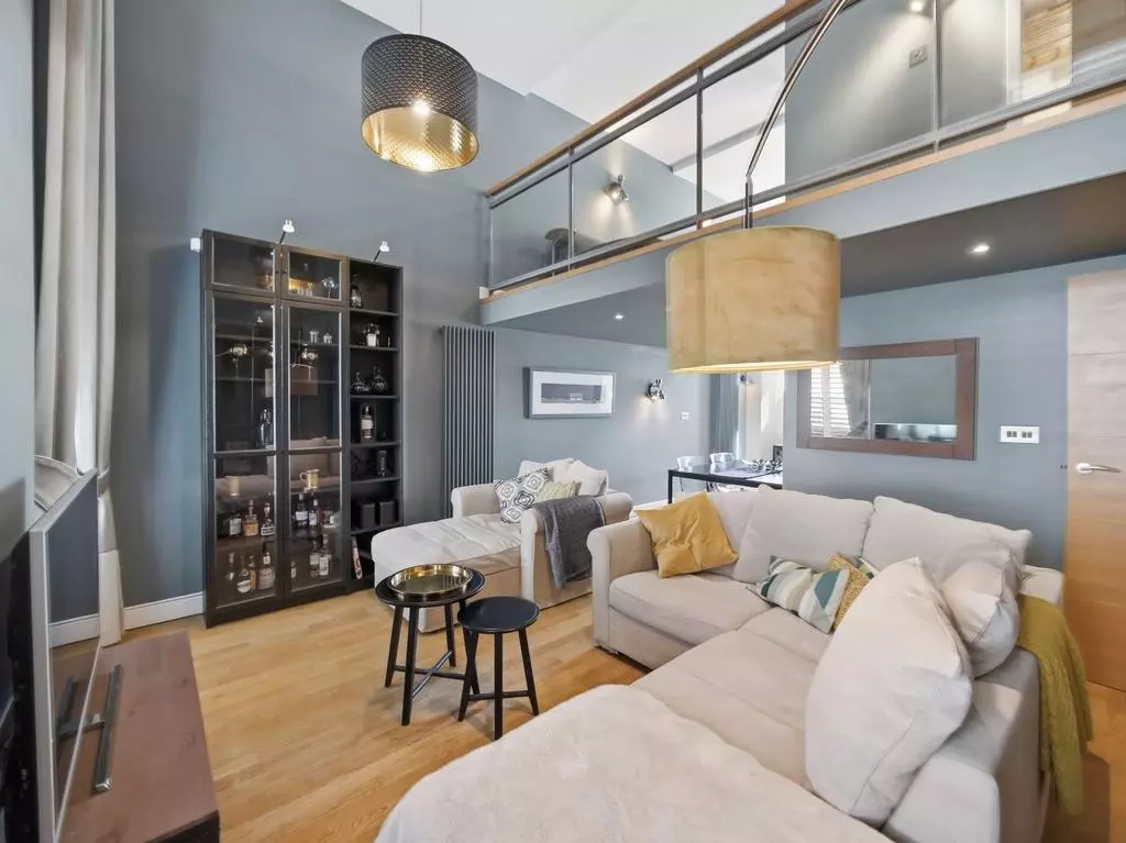 Open-plan living and dining space beneath the mezzanine