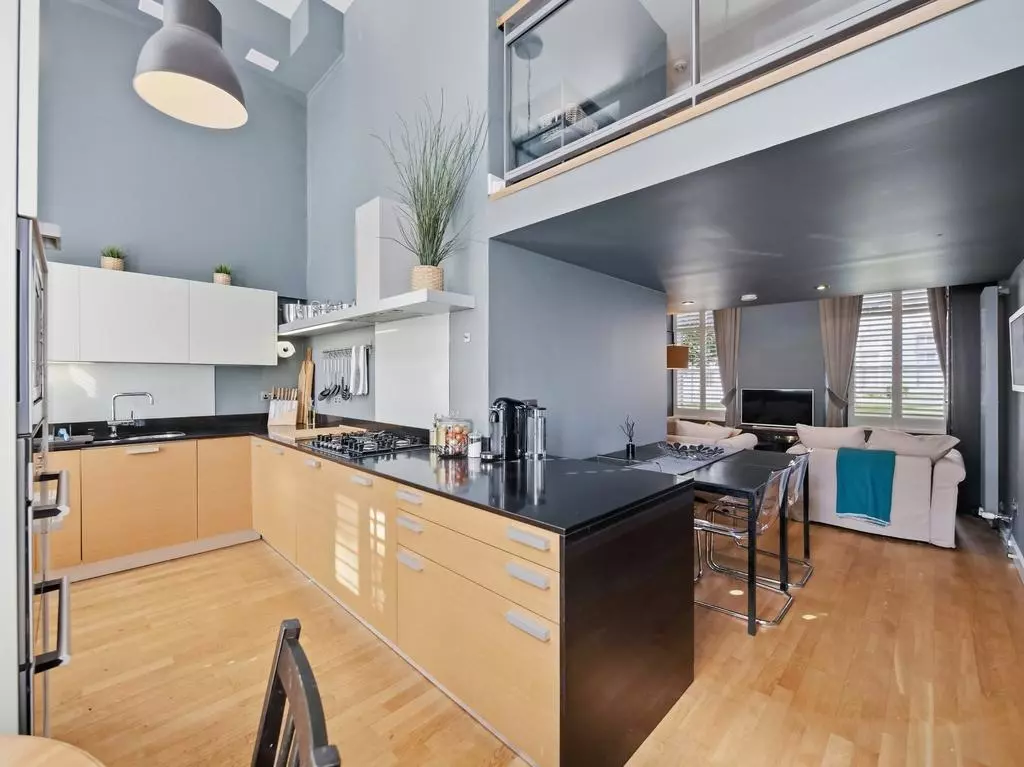 Contemporary fitted kitchen opening onto the living area