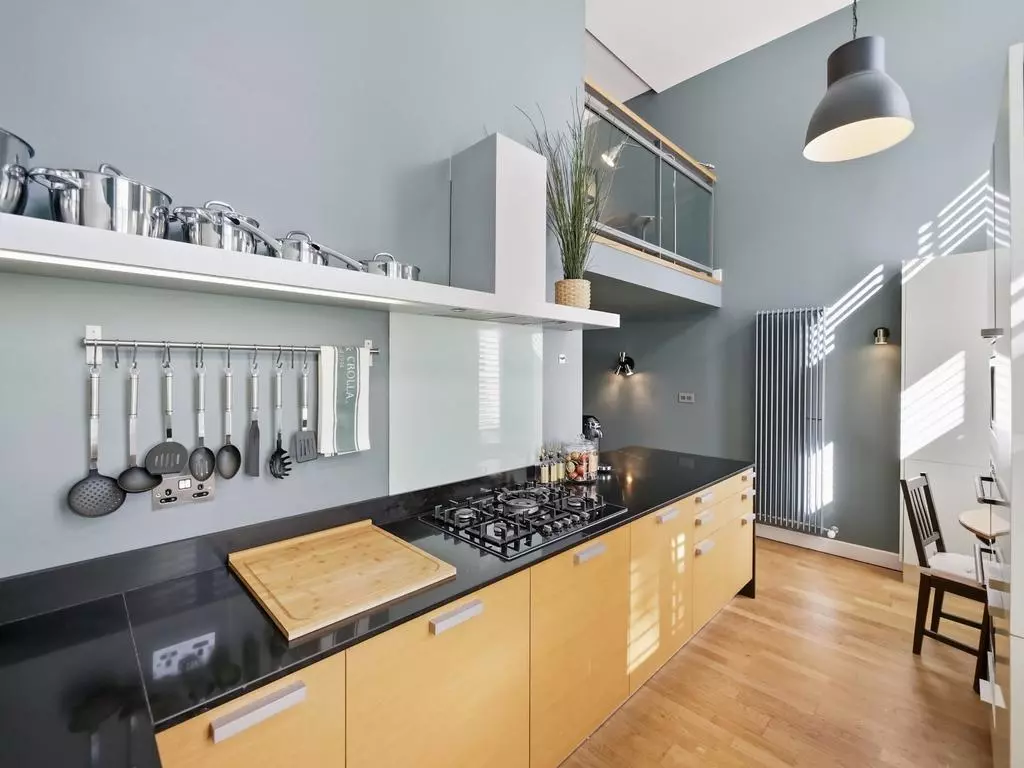 Modern kitchen with integrated appliances and coordinated splashback