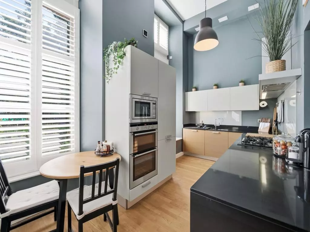 Kitchen dining area with large windows and integrated appliances