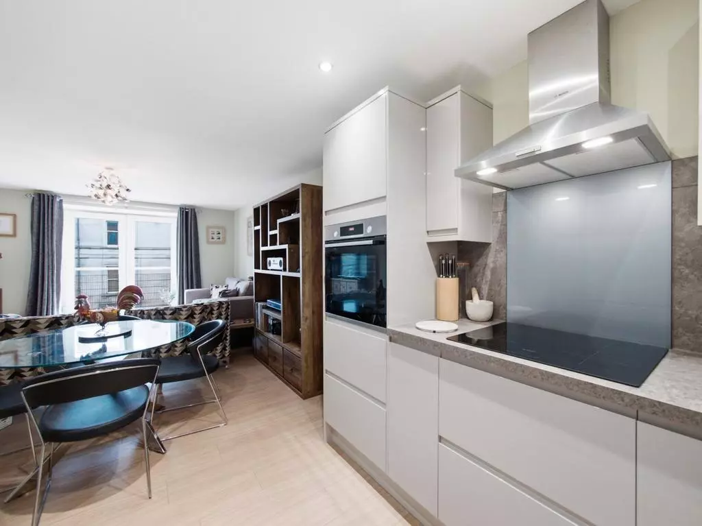 Modern kitchen opening onto the dining and living space