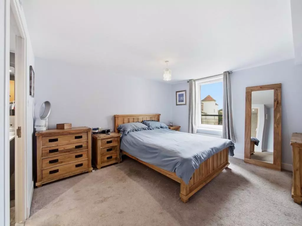 Principal double bedroom with bright window and en-suite access