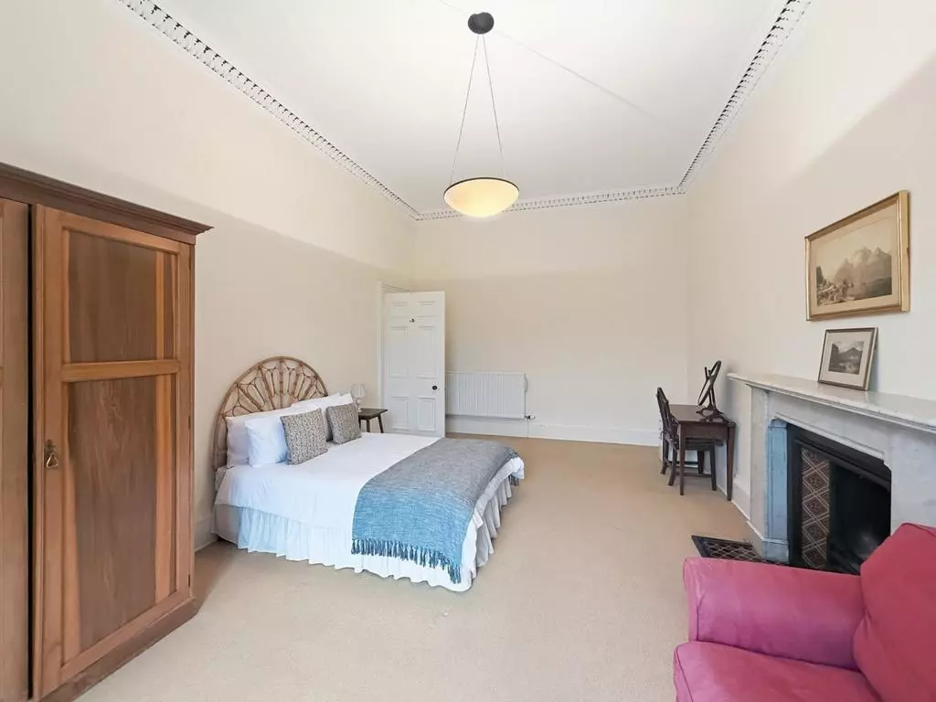 Second double bedroom with wardrobe, desk and period details