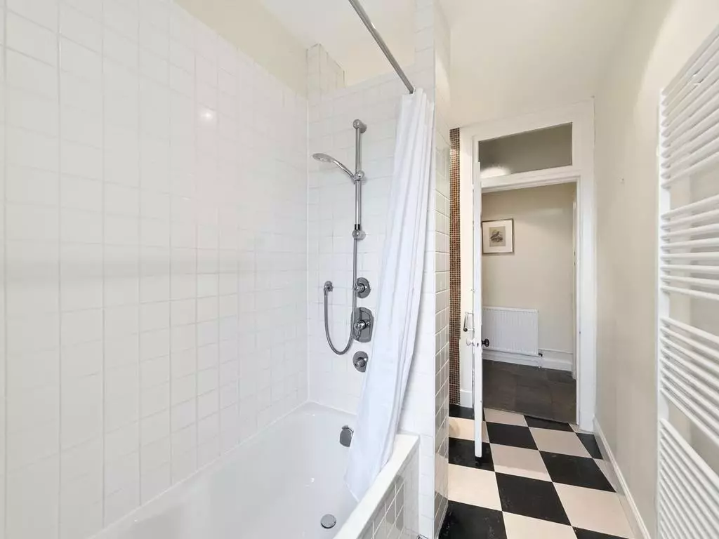 Bathtub with overhead shower and heated towel rail