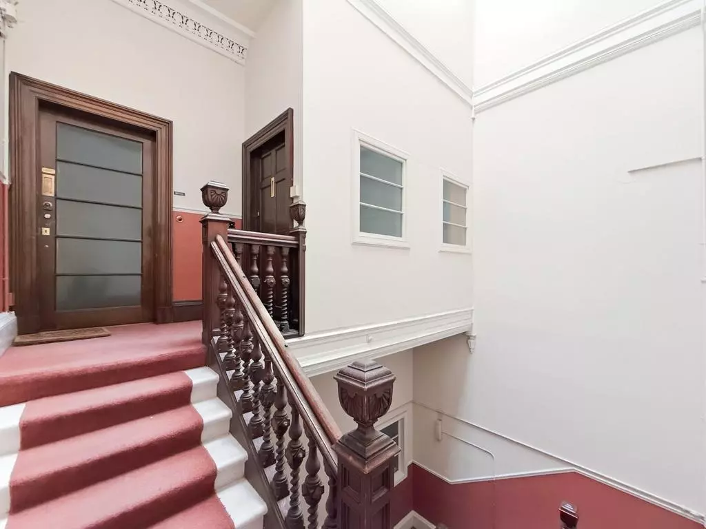 Period communal staircase leading to the second-floor flat