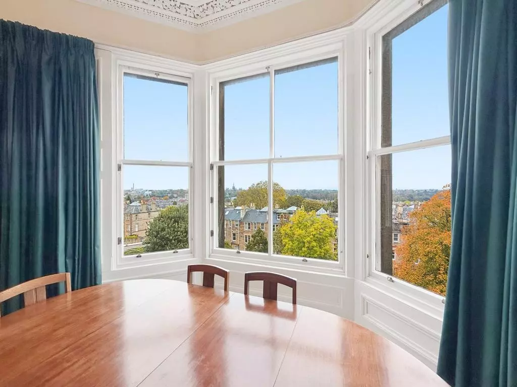 Dining area in the bay window overlooking Edinburgh rooftops