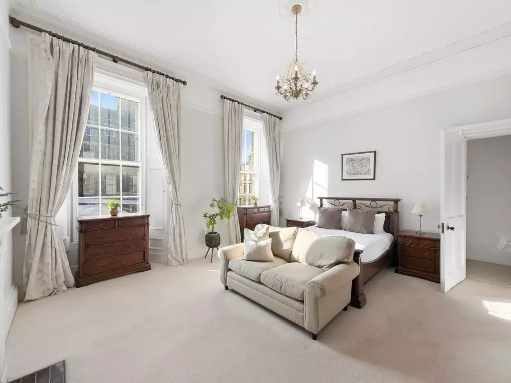 Versatile third bedroom with sofa seating and tall Georgian windows