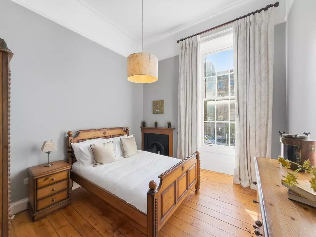 Second spacious double bedroom with timber floor and period fireplace