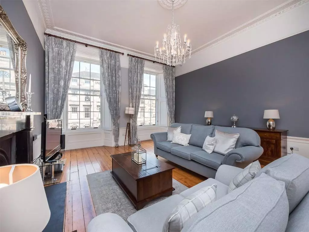 Elegant living room with tall sash windows and period cornicing