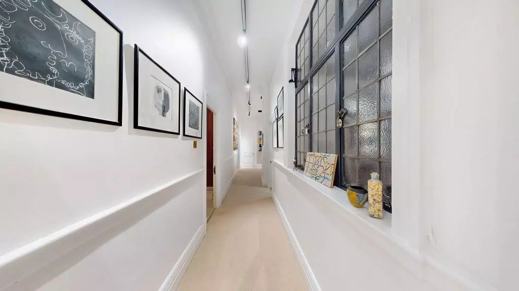 Apartment corridor with Art Deco-style internal glazing and framed artwork