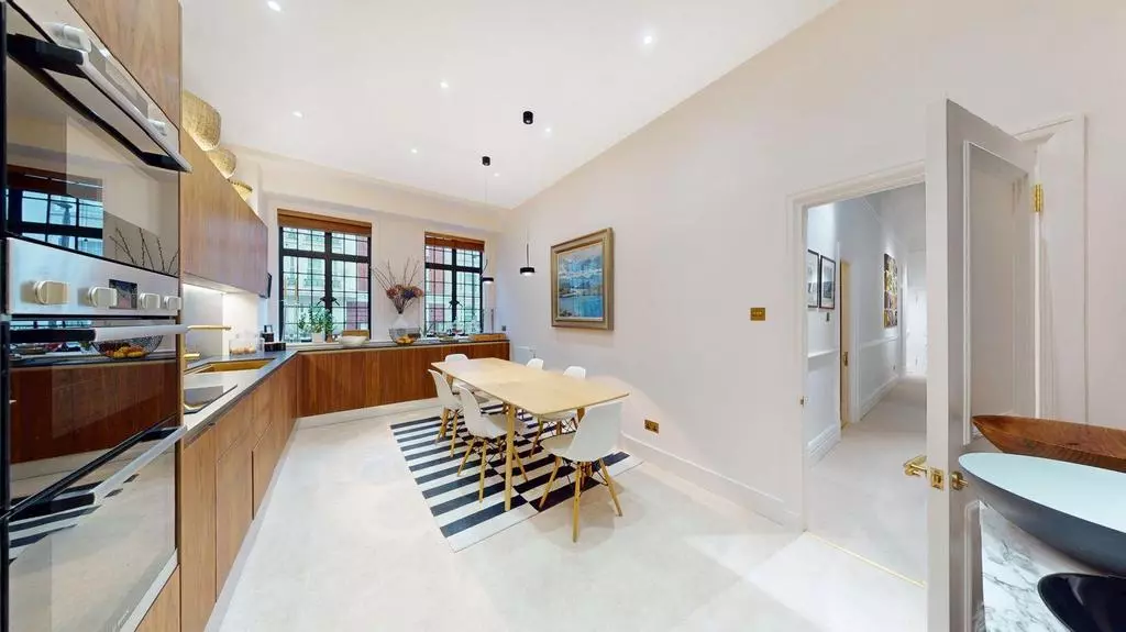 Large eat-in kitchen with timber cabinetry and integrated appliances