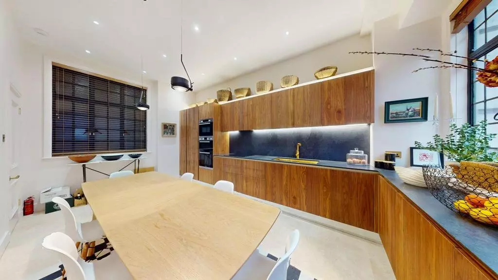 Kitchen dining area with timber table and extensive fitted storage