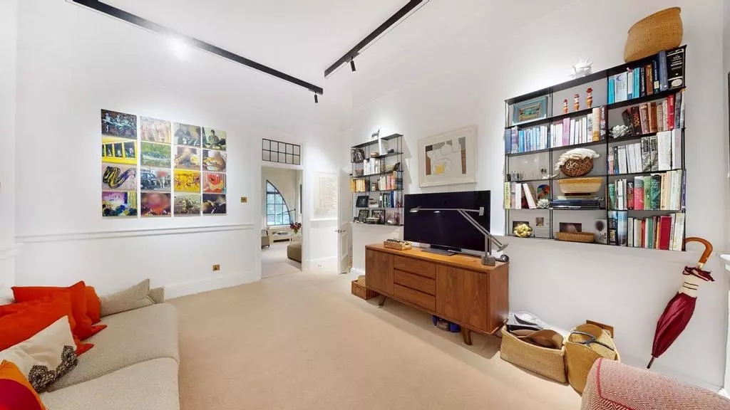 Separate media and study room with television and bespoke shelving