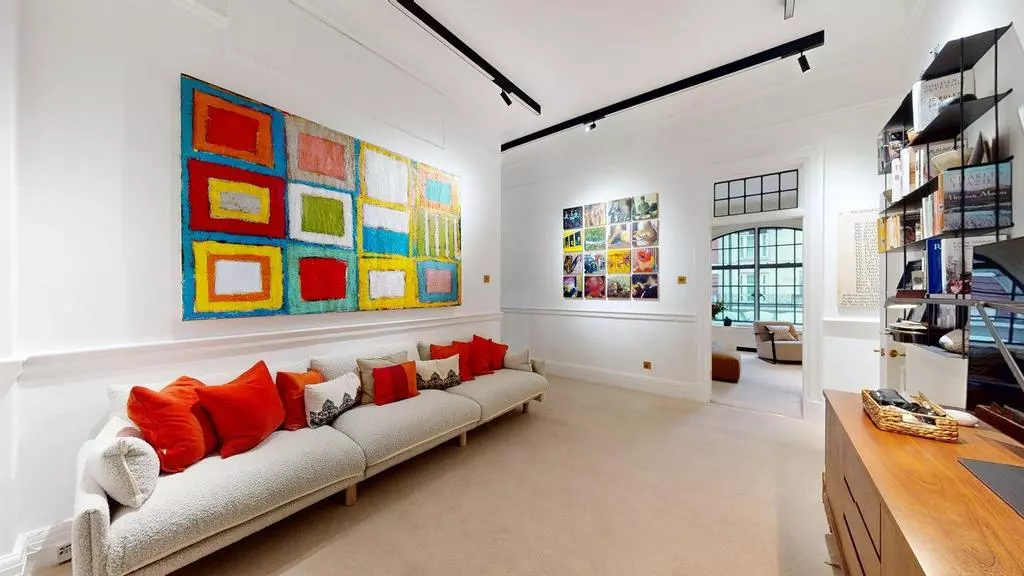 Comfortable study and television room with contemporary art and shelving