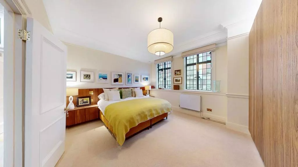 Spacious double bedroom with fitted wardrobes and soft neutral finishes