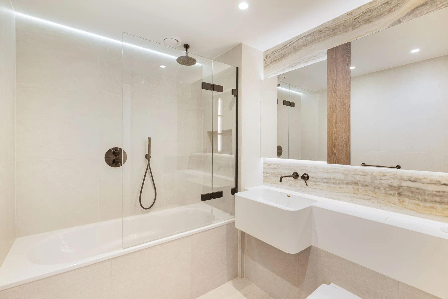 Second bathroom with bathtub overhead shower and stone vanity